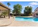 Backyard oasis features an inviting pool with patio and covered outdoor seating at 4220 E Everett Dr, Phoenix, AZ 85032