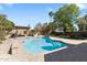 Backyard pool with a tanning ledge, a brick patio, lush landscaping, and a shaded pergola area at 4220 E Everett Dr, Phoenix, AZ 85032