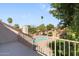 View from the balcony overlooking a backyard pool, a brick patio, and lush landscaping on a sunny day at 4220 E Everett Dr, Phoenix, AZ 85032