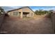 A spacious backyard with a covered patio and block wall, ready for your landscape design at 4943 W Lynne Ln, Laveen, AZ 85339