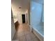 Bright bathroom featuring a soaking tub, tiled floor, walk-in closet and double sink vanity at 4943 W Lynne Ln, Laveen, AZ 85339