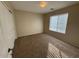 Neutral carpeted bedroom with one window and blank walls at 4943 W Lynne Ln, Laveen, AZ 85339