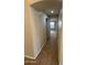 Hallway featuring neutral carpet and an archway entrance to a bedroom with a window at 4943 W Lynne Ln, Laveen, AZ 85339