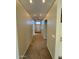 Hallway featuring neutral carpet, archways, and a view of the front door and transom window at 4943 W Lynne Ln, Laveen, AZ 85339