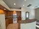 Kitchen featuring oak cabinets, white appliances, a breakfast bar, and tile flooring at 4943 W Lynne Ln, Laveen, AZ 85339