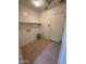 Functional laundry room features tile flooring, a shelf, and a door to the outside at 4943 W Lynne Ln, Laveen, AZ 85339
