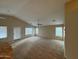Spacious living room with a ceiling fan, carpet, and multiple windows providing ample natural light at 4943 W Lynne Ln, Laveen, AZ 85339