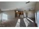 Bright living room featuring neutral carpet, ceiling fans, and views into an open-concept kitchen at 4943 W Lynne Ln, Laveen, AZ 85339