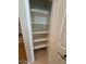 Pantry featuring white shelving for easy storage and tile flooring for quick cleanups at 4943 W Lynne Ln, Laveen, AZ 85339