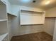 Walk-in closet featuring built-in shelving and hanging rods providing ample storage space at 4943 W Lynne Ln, Laveen, AZ 85339