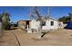 Exterior view of a single-story home with peeling white paint in disrepair and sparse landscaping at 508 S 98Th St, Mesa, AZ 85208