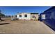 Side exterior view of a single-story home showing peeling paint and sparse landscaping at 508 S 98Th St, Mesa, AZ 85208
