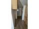 Compact kitchen area with wood-look flooring, ample cabinetry, and an exterior door at 508 S 98Th St, Mesa, AZ 85208