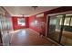 Living room with wood floors, ceiling fan, and sliding glass door; damaged walls at 508 S 98Th St, Mesa, AZ 85208
