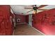 Spacious living room with wood floors, a ceiling fan, and damaged walls at 508 S 98Th St, Mesa, AZ 85208