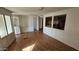 Open-concept living area with wood floors, an open wall, and a view into the kitchen at 508 S 98Th St, Mesa, AZ 85208