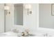 Close up of an elegant bathroom with a dual sink vanity and sconce lighting at 520 E Aurora Dr, San Tan Valley, AZ 85140