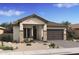 Charming single-story home featuring desert landscaping, a two-car garage, and a cozy front porch sitting area at 520 E Aurora Dr, San Tan Valley, AZ 85140
