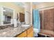 Bathroom featuring granite countertop, tile flooring, and a walk-in shower at 525 N Miller Rd # 113, Scottsdale, AZ 85257