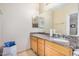 Bathroom featuring granite countertop, tile flooring, and large mirror at 525 N Miller Rd # 113, Scottsdale, AZ 85257