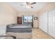 Bright bedroom with neutral walls, ceiling fan, closet and large window at 525 N Miller Rd # 113, Scottsdale, AZ 85257