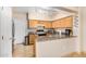 Bright kitchen features light wood cabinets and granite counters with a sink and stainless steel appliances at 525 N Miller Rd # 113, Scottsdale, AZ 85257