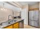 Spacious kitchen with granite counters, stainless steel appliances and view of the living room at 525 N Miller Rd # 113, Scottsdale, AZ 85257