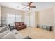 Bright living room with tile floors, ceiling fan, and natural light from the front window at 525 N Miller Rd # 113, Scottsdale, AZ 85257