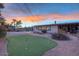 Spacious backyard with a putting green, pool, and patio, perfect for outdoor activities and relaxation at 6845 E Lewis Ave, Scottsdale, AZ 85257