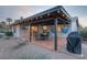 Charming backyard patio with outdoor dining, string lights, and hammocks, providing a perfect entertaining space at 6845 E Lewis Ave, Scottsdale, AZ 85257