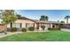 Charming single-story home featuring a well-manicured lawn, covered parking and mature trees at 6845 E Lewis Ave, Scottsdale, AZ 85257