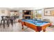 Entertaining game room area with a pool table, comfortable seating and a fireplace at 6845 E Lewis Ave, Scottsdale, AZ 85257