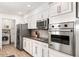 Modern kitchen boasts stainless steel appliances, lots of counter space, and white cabinets at 6845 E Lewis Ave, Scottsdale, AZ 85257