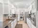 Well-equipped kitchen featuring stainless steel appliances, ample counter space, and sleek white cabinetry at 6845 E Lewis Ave, Scottsdale, AZ 85257