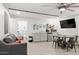 Open-concept living area with kitchenette, dining table, and comfortable seating, perfect for modern living at 6845 E Lewis Ave, Scottsdale, AZ 85257
