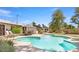 Backyard featuring a sparkling pool, patio seating, and lush landscaping, perfect for outdoor enjoyment at 6845 E Lewis Ave, Scottsdale, AZ 85257