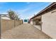 This backyard boasts a rock ground cover and block wall for privacy, and a storage shed at 8201 W Tuckey Ln, Glendale, AZ 85303