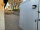 Backyard shed nestled amidst a gravel landscape, enclosed by a block wall for added privacy at 8201 W Tuckey Ln, Glendale, AZ 85303