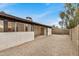 This backyard features rock ground cover, a block wall, a covered patio, and plenty of sunshine at 8201 W Tuckey Ln, Glendale, AZ 85303