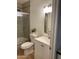Cozy bathroom with a white vanity, tile backsplash, glass-enclosed tub, and neutral decor at 8201 W Tuckey Ln, Glendale, AZ 85303