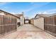 Gated driveway with a concrete surface is flanked by block walls and leads to a covered parking area at 8201 W Tuckey Ln, Glendale, AZ 85303