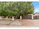 Charming home with a large shade tree, rock landscaping, and a two car garage at 8201 W Tuckey Ln, Glendale, AZ 85303