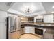 Modern kitchen features stainless steel appliances, granite countertops, and custom cabinetry at 8201 W Tuckey Ln, Glendale, AZ 85303