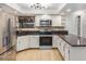Well-lit kitchen offers stainless steel appliances, granite countertops, and ample cabinet space at 8201 W Tuckey Ln, Glendale, AZ 85303