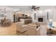 Bright, open-concept living room featuring hardwood floors, fireplace, and kitchen island with bar seating at 8201 W Tuckey Ln, Glendale, AZ 85303
