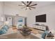 Spacious living room with high ceilings, large TV, and comfortable seating, creating an inviting atmosphere at 8201 W Tuckey Ln, Glendale, AZ 85303