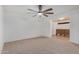 Bright living room features plush carpeting and a modern ceiling fan at 8201 W Tuckey Ln, Glendale, AZ 85303