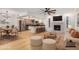 Bright, open-concept living room featuring hardwood floors, fireplace, and kitchen island with bar seating at 8201 W Tuckey Ln, Glendale, AZ 85303