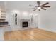 Bright living room features a brick fireplace, white shiplap accent wall, and updated ceiling fan at 8201 W Tuckey Ln, Glendale, AZ 85303