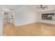 Spacious living room with wood floors, a modern ceiling fan, and a bright, airy feel at 8201 W Tuckey Ln, Glendale, AZ 85303
